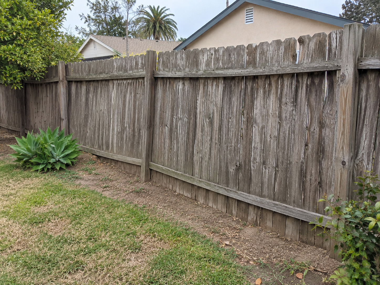Weathered fence before replacement